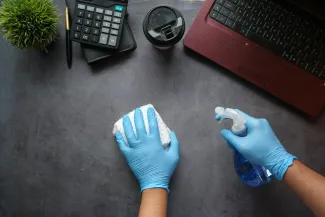 person in blue long sleeve shirt sitting beside black laptop computer by Towfiqu barbhuiya courtesy of Unsplash.