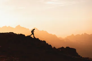 a person standing on top of a mountain by NEOM courtesy of Unsplash.